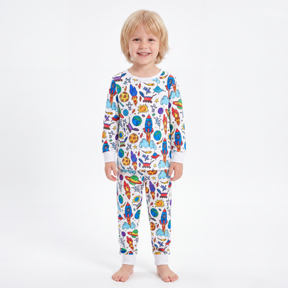 Boy wearing The Coloring Pajama in the Space & Galaxy print, fully colored in with vivid rockets and planets